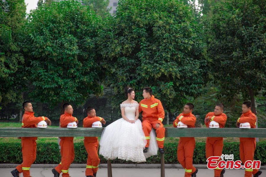 Firefighter poses for unconventional wedding photos