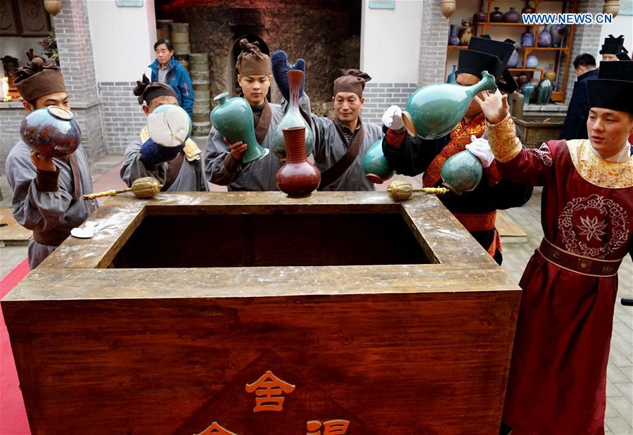 Ceremony taking porcelains out of kiln held in central China