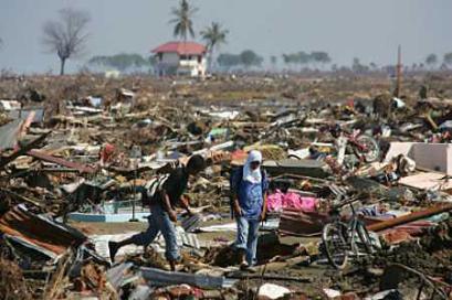 Tsunami survivors walk among debris from the quake-triggered tsunami in Banda Aceh on the Indonesian island of Sumatra on January 14, 2005. Aid agencies have prevented diseases spreading through Indonesia's tsunami-stricken Aceh, but the threat remained strong, the United Nations (news - web sites) said as doctors reported children dying from pneumonia. (Kimimasa Mayama/Reuters) 