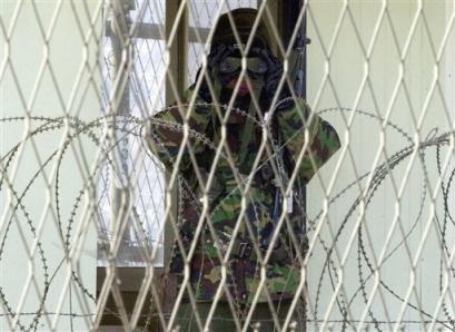 A South Korean Army soldier looks through his binoculars at an observation post at Imjingak pavilion, near the demilitarized zone of Panmunjom, South Korea, Sunday, Feb. 13, 2005. [AP]