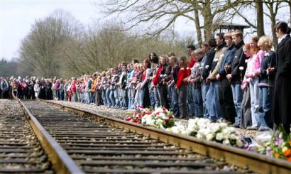 Young people attend a commemoration ceremony in the former Nazi deportation camp Westerbork in the Netherlands, Tuesday, April 12, 2005. Most Dutch victims, including teenage diarist Anne Frank, were held temporarily at camp Westerbork, near the German border. They later were sent to death camps in Germany and Poland. Westerbork was liberated by Canadian troops 60 years ago. (AP Photo/Bas Czerwinski). 