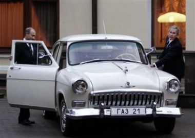 President Bush and Russian President Vladimir Putin climb into a vintage 1956 Volga to drive to dinner within his private residence compound in the Odinsovsky district outside Moscow Sunday, May 8, 2005. The Russian leader even let Bush drive the sedan around a driveway before heading to dinner with their wives. 'I'm having so much fun. We're going for another lap,' Bush said. (AP