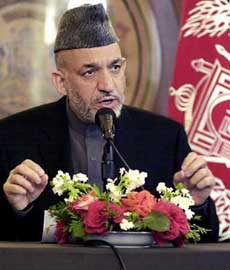 Afghanistan's President Hamid Karzai speaks during a news conference at the Presidential Palace in Kabul May 21, 2005. Karzai said on Saturday he was shocked by a U.S. army report on abuse of detainees in Afghanistan, saying his government wanted custody of all Afghan prisoners and control over U.S. military operations. 