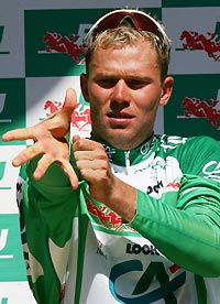 Credit Agricole team rider Thor Hushovd of Norway wears the sprinter's green jersey on the podium after the 187km (116 miles) 12th stage of the 92nd Tour de France cycling race between Briancon and Digne-Les-Bains, July 14, 2005.