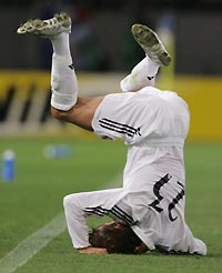 Real Madrid's David Beckham rolls over after being tackled by Tokyo Verdy's Kenichi Takahiro Soma during their friendly match at Ajinomoto Stadium in Tokyo July 25, 2005. 