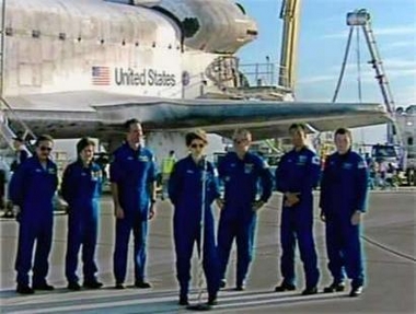 The crew of the space shuttle Discovery (L-R) Charlie Camarda, Wendy Lawrence, Steve Robinson, Commander Eileen Collins, Andy Thomas of Australia, Soichi Noguchi of Japan and Pilot James Kelly stand on the tarmac after their successful landing at Edwards Air Force base in California August 9, 2005.