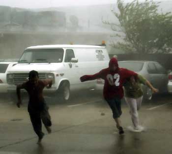 A train crossing light is torn down as Hurricane Katrina hit downtown Gulfport, Mississippi August 29, 2005. Hurricane Katrina ripped into the U.S. Gulf Coast on Monday, stranding people on rooftops as it pummeled the historic jazz city New Orleans with 100 mph (160 kph) winds and swamped Mississippi resort towns and lowlands with a crushing surge of seawater.