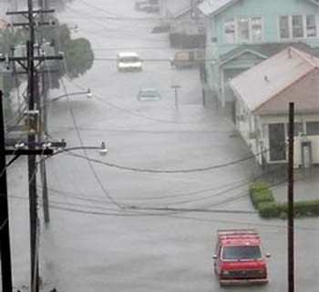 Cars sit idle on flooded streets in downtown New Orleans after Hurricane Katrina came ashore on Monday, Aug. 29, 2005. (AP