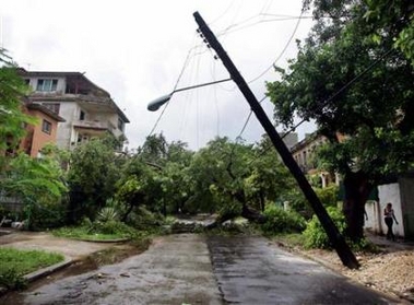 Uprooted trees and half-fallen power cables block a street in Havana after Hurricane Rita passed near Cuba September 21, 2005.