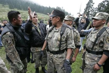 Mexico State police coordinate a search effort for a missing helicopter in the hills on the outskirts of Toluca, Mexico on Wednesday Sept. 21, 2005. 