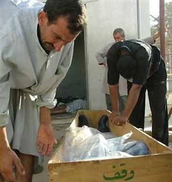 Iraqis prepare to carry the coffin of one of the five elementary school teachers shot dead by suspected insurgents disguised as policemen in Muelha, Iraq, Monday, Sept. 26, 2005. 