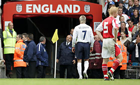 England's David Beckham (L) walks from the pitch after being shown the red card, as Austria's Andreas Ibertsberger (R) looks on, during their World Cup 2006, Group Six qualifying soccer match at Old Trafford in Manchester, northern England, October 8, 2005. 