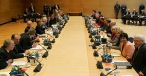 Germany's conservative Christian Democratic Union party (CDU) delegation (L) and Social Democrats (SPD) delegation (R) start their first round of coalition talks at the Social Democrats headquarter in Berlin October 17, 2005.