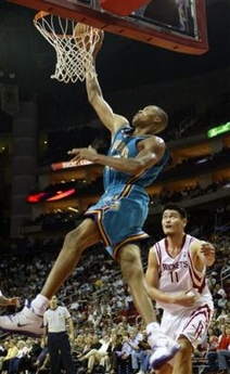 New Orleans Hornets' PJ Brown, left, takes the ball to the basket as Houston Rockets' Yao Ming, right, looks on in the second half of play on Wednesday, Nov. 5, 2005, in Houston. Hornets won 91-84. 