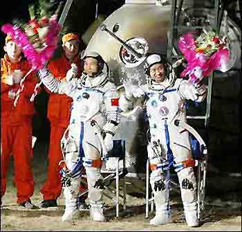 Photo dated October 2005 shows Chinese austronauts Fei Junlong and Nie Haisheng at the Shenzhou VI space capsule's landing site in northern China. 