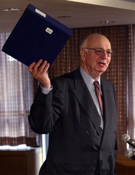 Paul Volker, chairman of the Independent Inquiry Committee into the UN oil-for-food program, holds up his report as he announces companies involved in sales of Iraqi oil and the export of goods to Iraq, during a news conference in New York, Oct. 21, 2004.