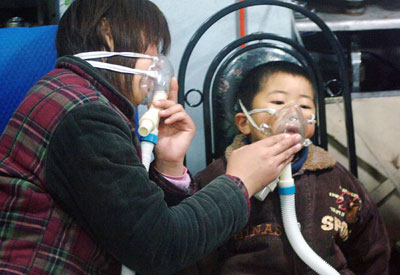 A Chinese woman and her son receive medical treatment for carbon monoxide poisoning at a local hospital in Hefei, in China's Anhui province, February 15, 2006. Several people were poisoned by carbon monoxide, a highly toxic gas, due to the improper usage of natural gas at home. Three people were left dead and 87 people injured, according to Xinhua News Agency. 