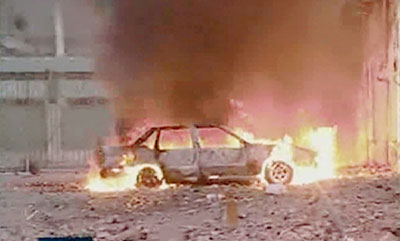 A car burns near the Italian consulate in the northeastern city of Benghazi, Libya February 17, 2006. About 10 people were killed in violent clashes between Libyan police and demonstrators on Friday at a protest over cartoons of the Prophet Mohammad, Italian ambassador to Tripoli Francesco Trupiano said.