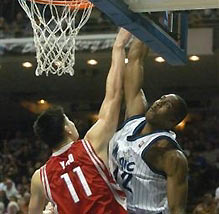 Orlando Magic forward Dwight Howard, right, goes up for a shot over Houston Rockets center Yao Ming, of China, during the first half of their NBA basketball game in Orlando, Fla., Sunday, Feb. 26, 2006. 