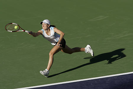 Number one seed Justine Henin-Hardenne of Belgium lunges for a forehand during a workout at the Pacific Life Open in Indian Wells, California, March 7, 2006. [Reuters]