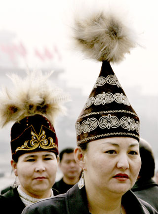 Chinese ethnic minority delegates arrive at the Great Hall of the People before the National People's Congress session in Beijing March 9, 2006. 