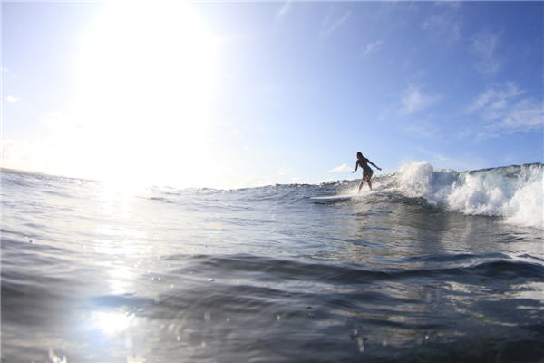 Female surfer rides China's waves