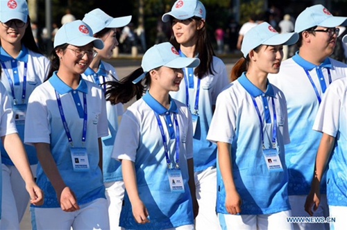 Volunteers seen on street in host city of 18th SCO Qingdao Summit