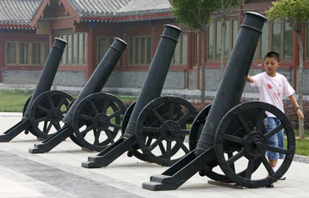 A boy touches old cannons which are displayed at Marco Polo Bridge on the outskirts of Beijing July 6, 2007, on the eve of the 70th anniversary of Japan's full-scale invasion of China. The exhibit coincides with the 70th anniversary of the July 7, 1937 skirmish at the Marco Polo Bridge near Beijing, which sparked an all-out war between China and Japan.[Reuters]