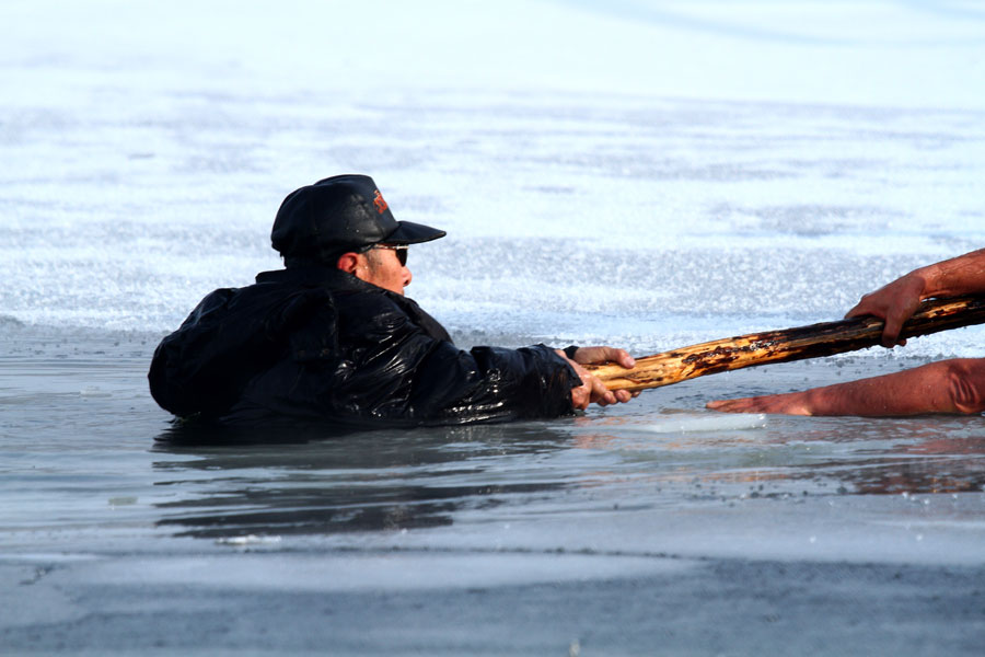 Man saved after falling through frozen lake