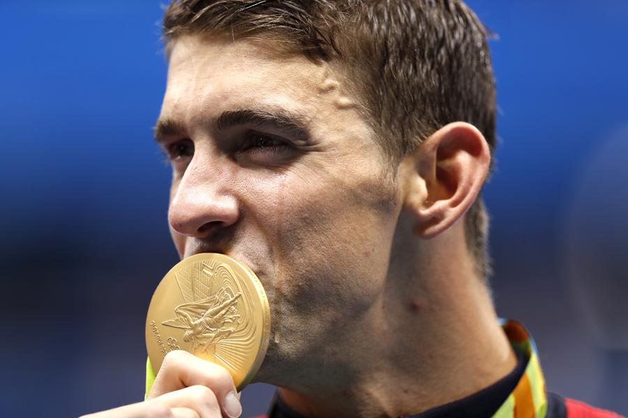 Phelps adds Olympic gold medal haul to historic 21