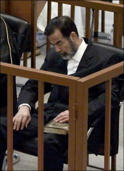 The trial of Saddam Hussein and seven co-defendants over the massacre of Shiite villagers resumed with the ejection of one of Saddam's female defense attorneys. Picture shows Saddam during a trial session last week. [AFP]