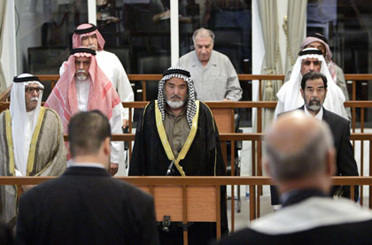 (1st row L to R) Abdullah Kadhem Ruaid, Mohammad Azawi Ali, Saddam Hussein, (2nd row L to R) Awad Hamed al-Bander, Mizher Abdullah Rawed, (3rd row L to R) Barzan Ibrahim al-Tikriti, Ali Daeem Ali, Taha Yassin Ramadan attend their trial held in Baghdad's heavily fortified Green Zone May 22, 2006. The trial of Saddam Hussein and seven others accused of crimes against humanity resumed in Baghdad on Monday, with defence witnesses for some of the more senior defendants expected to take the stand.