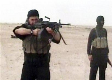 Abu Musab al-Zarqawi (L), leader of al Qaeda in Iraq, in footage obtained by the Pentagon and released on May 4, 2006. Oil fell to below $70 for the first time in two weeks on Thursday after the death of al Qaeda'a leader in Iraq, where crude exports have been curbed by frequent sabotage attacks and instability. [Reuters]