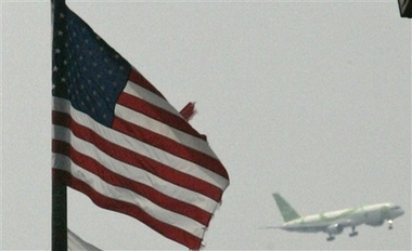 A plane lands Saturday, June 2, 2007 at John F. Kennedy International Airport in the Queens borough of New York. Three people were arrested and another was being sought Saturday for allegedly plotting to blow up a fuel line that feeds John F. Kennedy International Airport and runs through residential neighborhoods, authorities said. The plot never got past the planning stages. It posed no threat to air safety or the public, the FBI said Saturday. (AP 