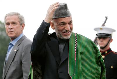 Aghanistan President Hamid Karzai, center, arrives at Camp David on Sunday for a two-day visit with President Bush.