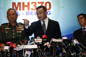 Malaysian police search home of missing plane's pilot